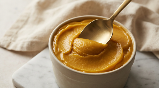 Close-up macro of a gelato spoon pressing into dense mango gelato — Crèm Gelato